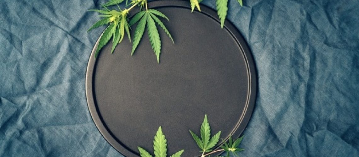template-with-marijuana-leaves-dark-background-cannabis-products-cbd-oil_296062-173